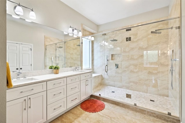 10129 Brimfield Dr, Austin, TX 78726 - full bathroom with double vanity, a stall shower, and tile patterned floors