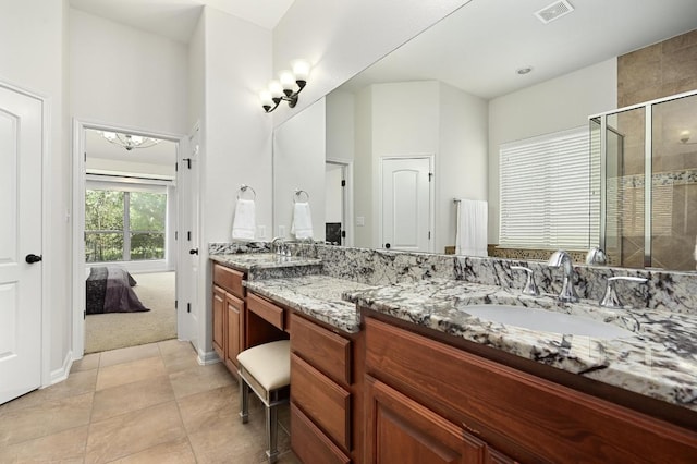 12404 Montclair Bnd, Austin, TX 78732 - full bathroom with double vanity, a shower stall, ensuite bath, and tile patterned floors