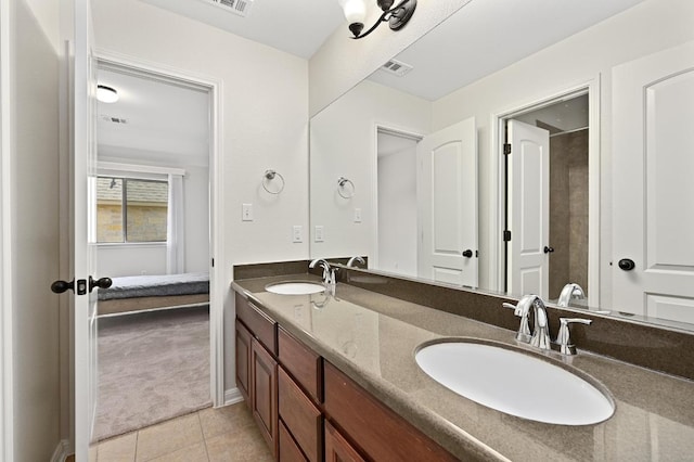 12404 Montclair Bnd, Austin, TX 78732 - full bathroom with double vanity, connected bathroom, tile patterned flooring, and baseboards