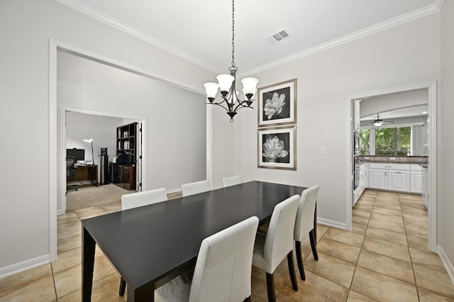 12404 Montclair Bnd, Austin, TX 78732 - dining area featuring light tile patterned floors, crown molding, a chandelier, and baseboards