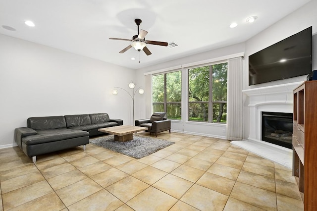 12404 Montclair Bnd, Austin, TX 78732 - living room featuring ceiling fan, light tile patterned flooring, a glass covered fireplace, recessed lighting, and baseboards