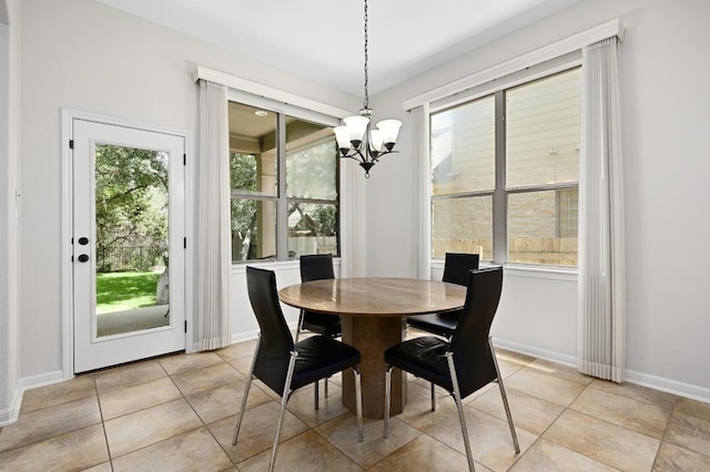 12404 Montclair Bnd, Austin, TX 78732 - dining area featuring a chandelier, plenty of natural light, light tile patterned floors, and baseboards