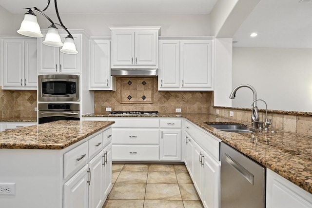 12404 Montclair Bnd, Austin, TX 78732 - kitchen featuring appliances with stainless steel finishes, a sink, white cabinets, tasteful backsplash, and recessed lighting