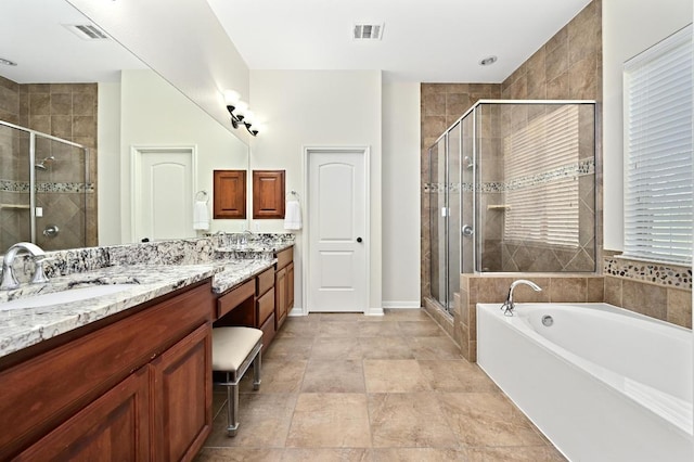 12404 Montclair Bnd, Austin, TX 78732 - bathroom featuring double vanity, a shower stall, a bath, and baseboards