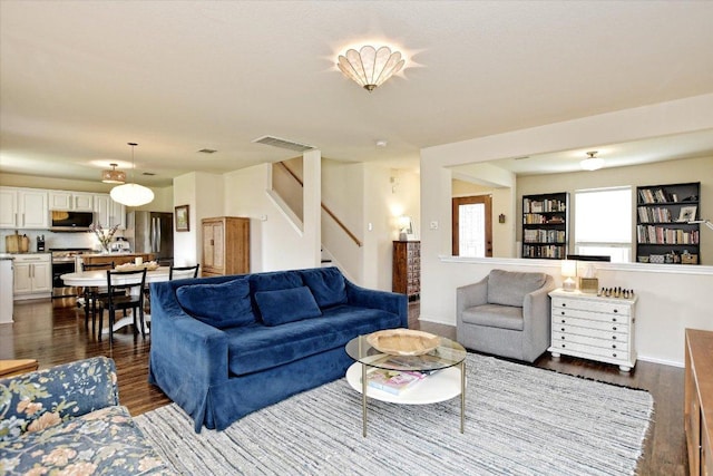 510 W Metcalfe St, Hutto, TX 78634 - living room with dark wood-type flooring and stairs