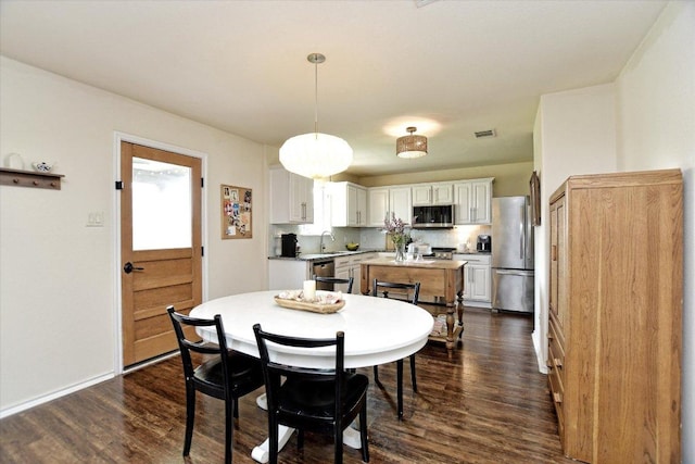 510 W Metcalfe St, Hutto, TX 78634 - dining room featuring dark wood-type flooring