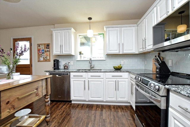 510 W Metcalfe St, Hutto, TX 78634 - kitchen featuring appliances with stainless steel finishes, a sink, dark wood-type flooring, white cabinets, and tasteful backsplash