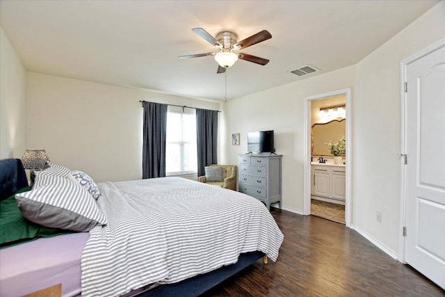 510 W Metcalfe St, Hutto, TX 78634 - bedroom featuring dark wood-style floors, ensuite bathroom, a ceiling fan, and baseboards