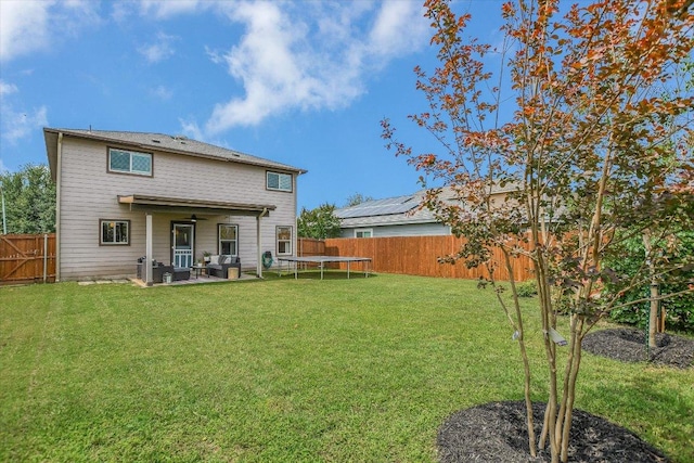 510 W Metcalfe St, Hutto, TX 78634 - back of property featuring a trampoline, ceiling fan, a fenced backyard, and a patio area