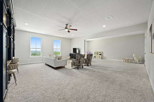 467 Cortaro Dr, Dripping Springs, TX 78620 - carpeted living room with ceiling fan, a textured ceiling, baseboards, and recessed lighting