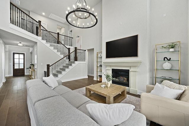 467 Cortaro Dr, Dripping Springs, TX 78620 - living room with wood finished floors, baseboards, a chandelier, a towering ceiling, and stairway