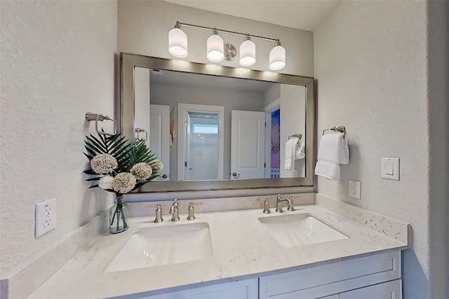 467 Cortaro Dr, Dripping Springs, TX 78620 - bathroom with double vanity and a textured wall
