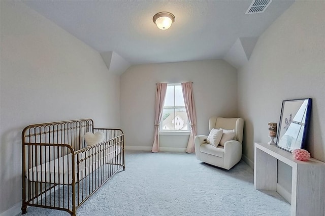 467 Cortaro Dr, Dripping Springs, TX 78620 - bedroom with a nursery area, vaulted ceiling, carpet floors, and baseboards