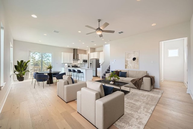 1531 N Red Bud Ln Unit 20, Round Rock, TX 78665 - living room featuring ceiling fan, stairway, light wood-style flooring, recessed lighting, and baseboards
