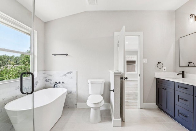 8804 Ravello Pass, Austin, TX 78749 - full bath with a freestanding tub, vanity, vaulted ceiling, and tile patterned floors