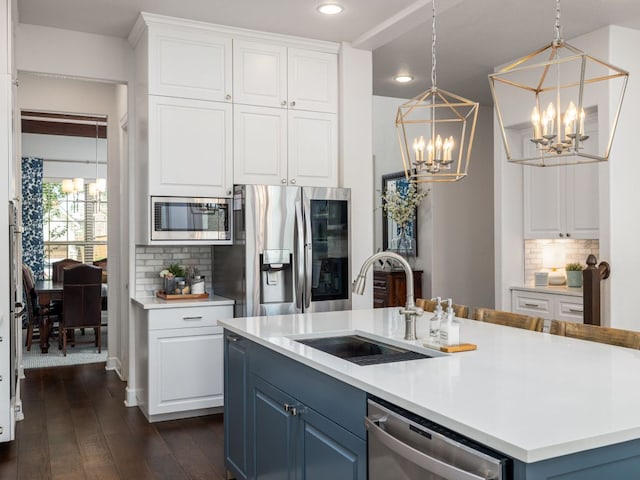 108 Brantley Lake Ln, Georgetown, TX 78628 - kitchen with appliances with stainless steel finishes, a chandelier, a sink, white cabinetry, and recessed lighting