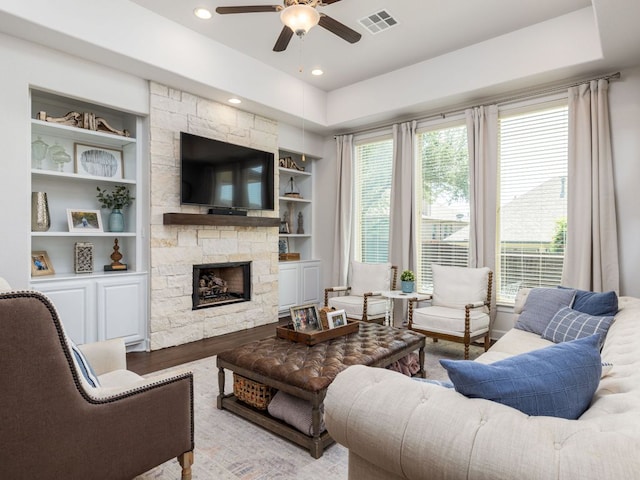 108 Brantley Lake Ln, Georgetown, TX 78628 - living room with a ceiling fan, built in shelves, a fireplace, wood finished floors, and recessed lighting