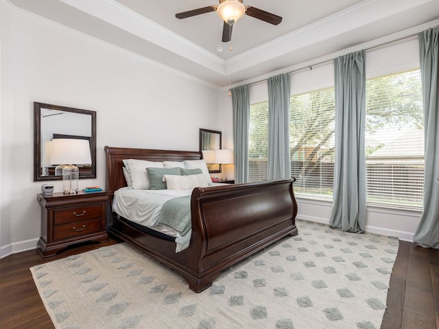 108 Brantley Lake Ln, Georgetown, TX 78628 - bedroom featuring multiple windows, wood finished floors, baseboards, ornamental molding, and a raised ceiling
