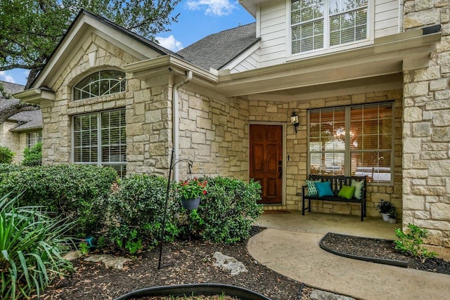 2012 Wood Glen Dr, Round Rock, TX 78681 - doorway to property featuring stone siding, a porch, and roof with shingles
