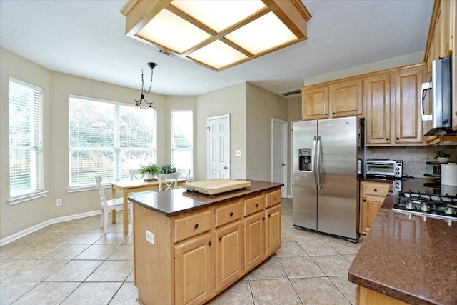2012 Wood Glen Dr, Round Rock, TX 78681 - kitchen featuring stainless steel appliances, dark countertops, light tile patterned floors, and a kitchen island