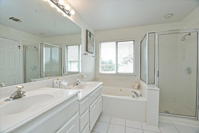 2012 Wood Glen Dr, Round Rock, TX 78681 - bathroom featuring double vanity, a shower stall, a garden tub, and tile patterned flooring