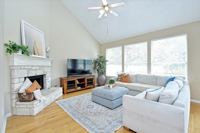 2012 Wood Glen Dr, Round Rock, TX 78681 - living area with light wood-style floors, ceiling fan, high vaulted ceiling, a fireplace, and baseboards