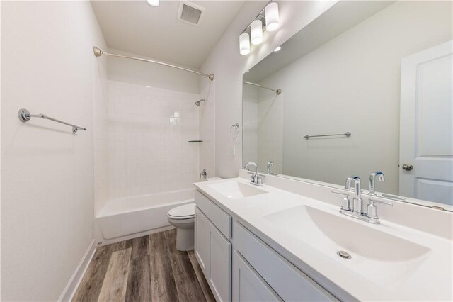748 Hazy Hills Loop, Dripping Springs, TX 78620 - full bath featuring toilet,  shower combination, wood finished floors, double vanity, and baseboards