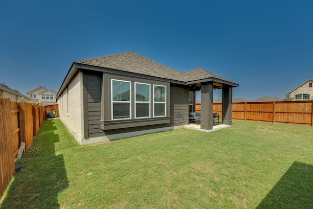 111 Blackwell Ln, Kyle, TX 78640 - back of house with roof with shingles and a patio area