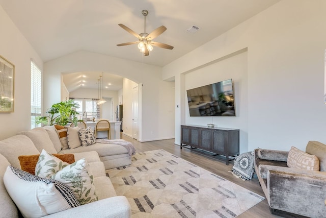 111 Blackwell Ln, Kyle, TX 78640 - living area featuring ceiling fan, wood finished floors, vaulted ceiling, and arched walkways