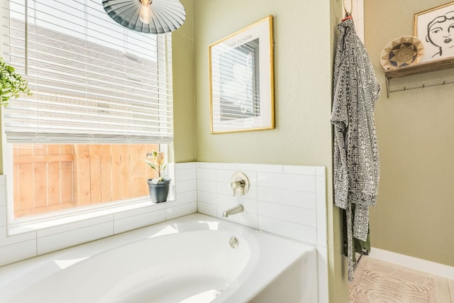 111 Blackwell Ln, Kyle, TX 78640 - bathroom with healthy amount of natural light and a garden tub