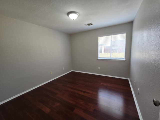 13820 Ceylon Tea Cir, Pflugerville, TX 78660 - unfurnished room with wood finished floors, baseboards, and a textured wall