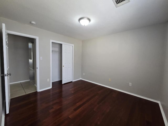 13820 Ceylon Tea Cir, Pflugerville, TX 78660 - unfurnished bedroom featuring wood finished floors, baseboards, and a closet