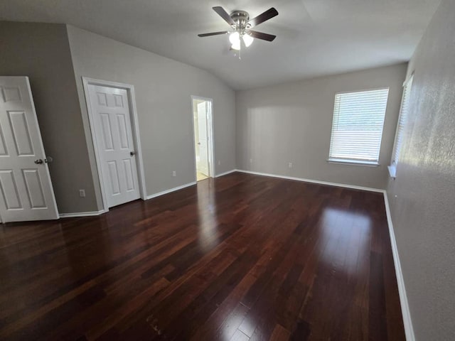 13820 Ceylon Tea Cir, Pflugerville, TX 78660 - unfurnished bedroom featuring dark wood finished floors, vaulted ceiling, baseboards, and ceiling fan