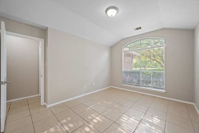 13820 Ceylon Tea Cir, Pflugerville, TX 78660 - empty room featuring light tile patterned flooring, vaulted ceiling, and baseboards