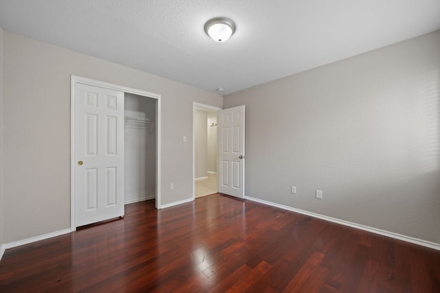 13820 Ceylon Tea Cir, Pflugerville, TX 78660 - unfurnished bedroom featuring wood finished floors, baseboards, and a closet