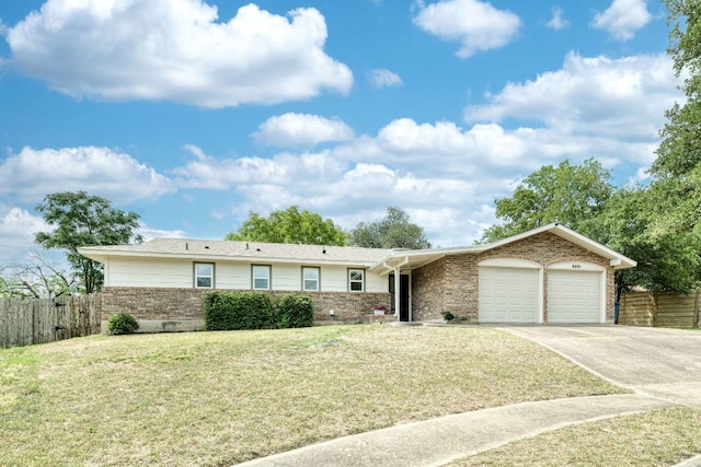 9001 Lodge Ct, Austin, TX 78758 - ranch-style home with an attached garage, brick siding, and driveway