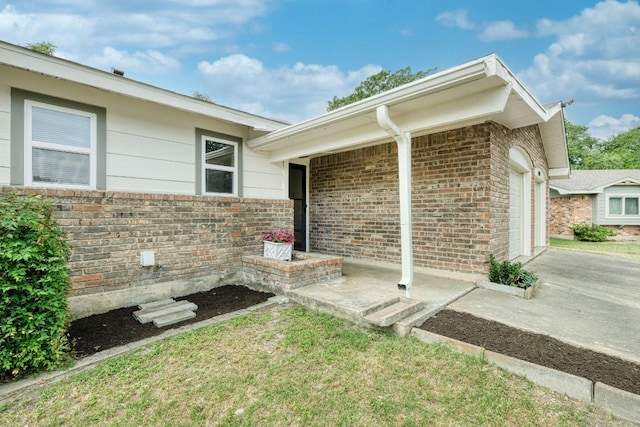 9001 Lodge Ct, Austin, TX 78758 - doorway to property featuring a garage and brick siding
