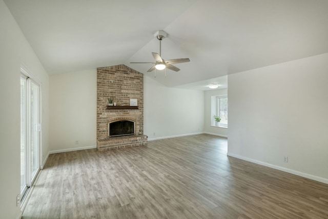 9001 Lodge Ct, Austin, TX 78758 - unfurnished living room with ceiling fan, wood finished floors, a fireplace, and vaulted ceiling