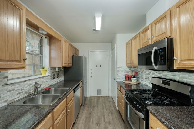 9001 Lodge Ct, Austin, TX 78758 - kitchen with appliances with stainless steel finishes, light wood finished floors, and tasteful backsplash