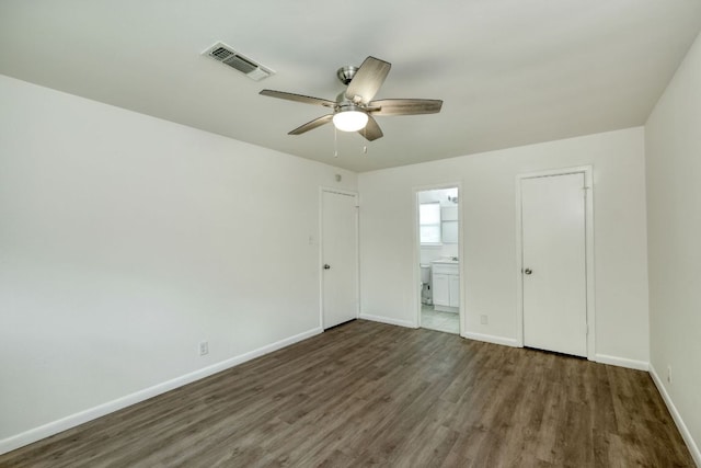 9001 Lodge Ct, Austin, TX 78758 - unfurnished bedroom with wood finished floors, ensuite bath, and ceiling fan
