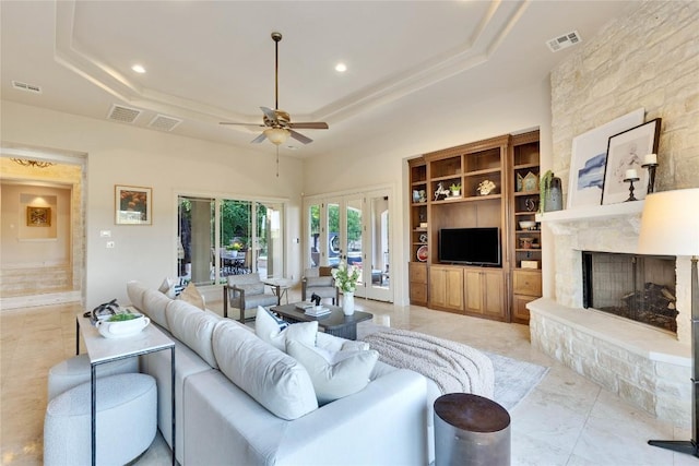 7116 Greenshores Dr, Austin, TX 78730 - living room featuring ceiling fan, a tray ceiling, a fireplace, a high ceiling, and recessed lighting