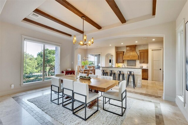 7116 Greenshores Dr, Austin, TX 78730 - dining room featuring inlaid floor details, a chandelier, beamed ceiling, recessed lighting, and arched walkways