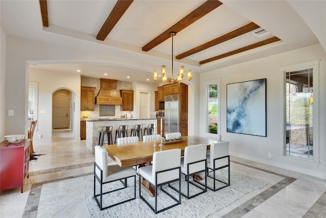 7116 Greenshores Dr, Austin, TX 78730 - dining area with inlaid floor details, arched walkways, baseboards, a chandelier, and a raised ceiling