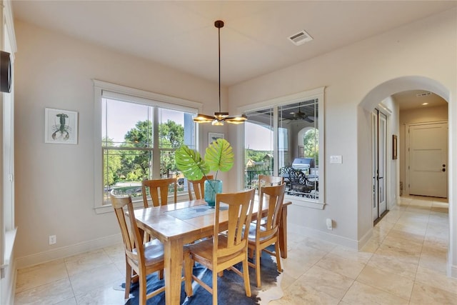 7116 Greenshores Dr, Austin, TX 78730 - dining area featuring arched walkways, baseboards, light tile patterned floors, and ceiling fan