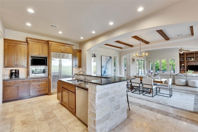 7116 Greenshores Dr, Austin, TX 78730 - kitchen featuring built in appliances, a sink, dark stone counters, recessed lighting, and backsplash