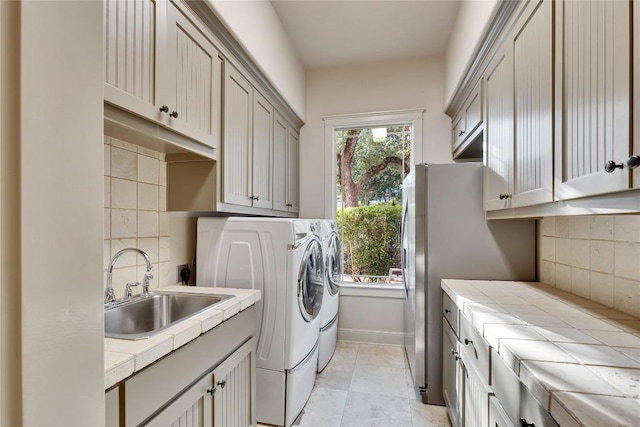 7116 Greenshores Dr, Austin, TX 78730 - washroom with cabinet space, washing machine and dryer, and baseboards