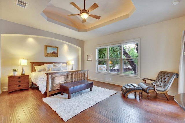 7116 Greenshores Dr, Austin, TX 78730 - bedroom with a tray ceiling, wood finished floors, baseboards, and a ceiling fan