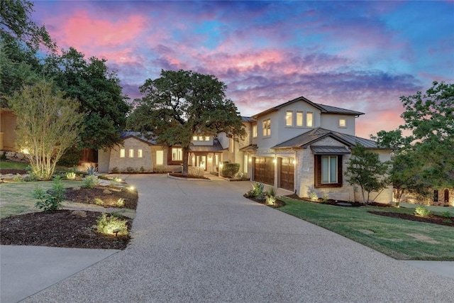 7116 Greenshores Dr, Austin, TX 78730 - view of front of house with a standing seam roof, driveway, an attached garage, metal roof, and a front lawn