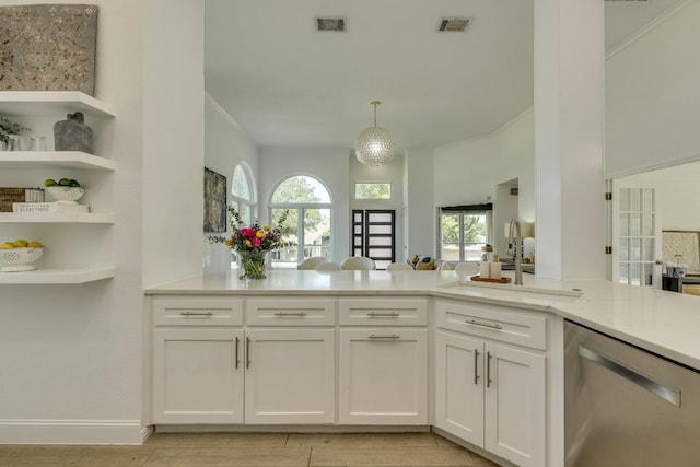 101 Peterson Ct, Austin, TX 78734 - kitchen featuring stainless steel dishwasher, light wood finished floors, white cabinets, crown molding, and a sink