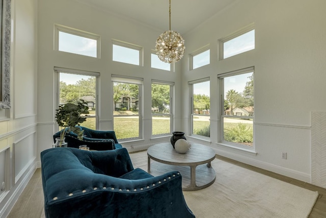 101 Peterson Ct, Austin, TX 78734 - sunroom / solarium featuring a chandelier, wood finished floors, ornamental molding, and a high ceiling